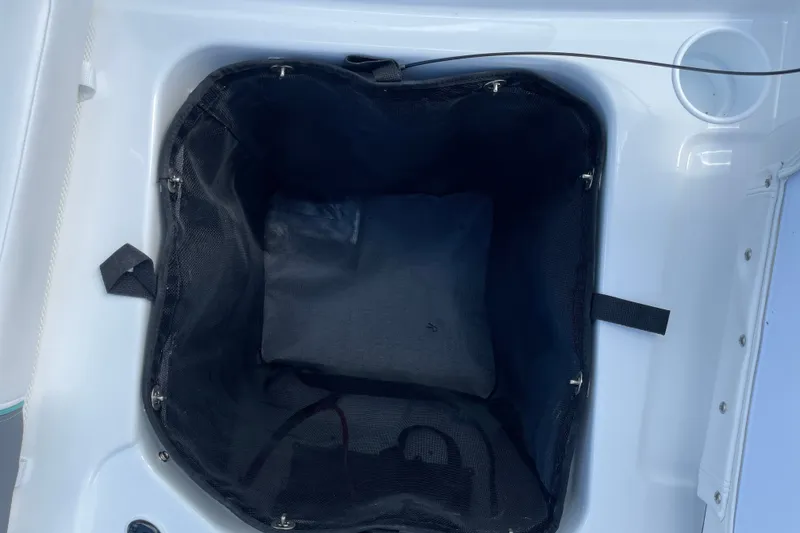 Slide: The Image of Storage compartment of 2027 Tahoe T21 boat, featuring a black mesh liner. - 28