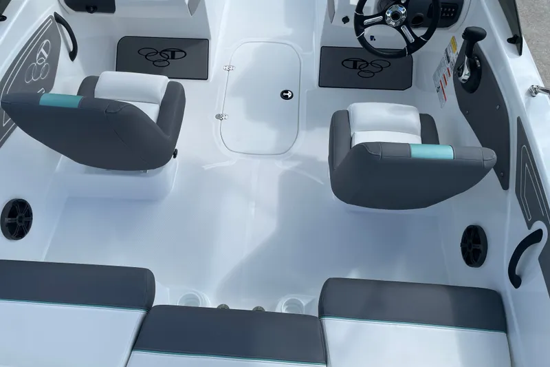 Slide: The Image of Interior of 2027 Tahoe T21 boat with gray and white seating, steering wheel, and storage. - 20