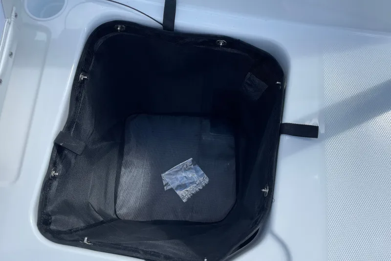 Slide: The Image of Storage compartment in 2027 Tahoe T21 boat with black mesh liner. - 27