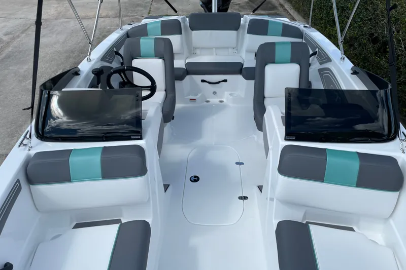 Slide: The Image of 2027 Tahoe T21 boat interior with modern seating and dual consoles. - 9