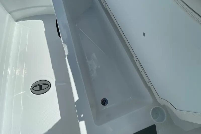 Slide: The Image of Storage compartment of 2027 Tahoe T21 boat, featuring sleek white interior design. - 22