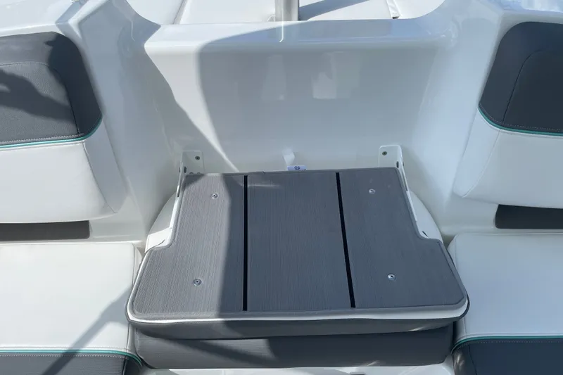 Slide: The Image of 2027 Tahoe T21 boat interior with gray cushioned seating and sleek design. - 16