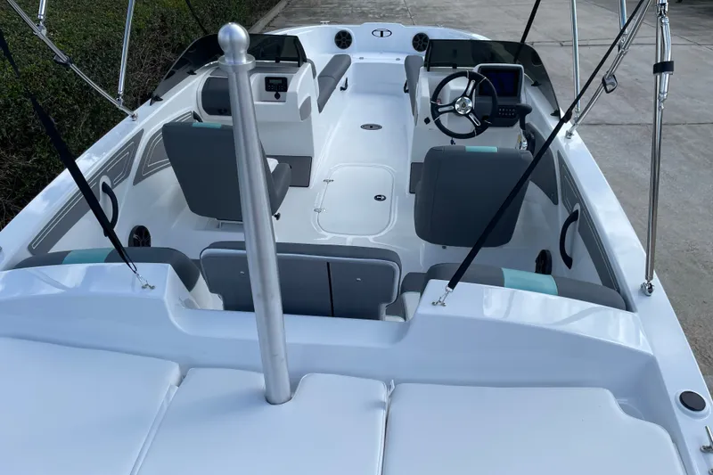 Slide: The Image of 2027 Tahoe T21 boat interior with modern seating and steering console. - 19
