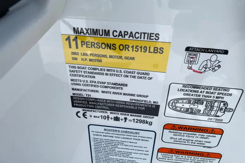 Slide: The Image of 2027 Tahoe T21 boat capacity label, 11 persons or 1519 lbs, safety warnings included. - 31