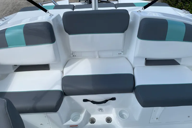 Slide: The Image of 2027 Tahoe T21 boat interior with gray and teal cushioned seating. - 14