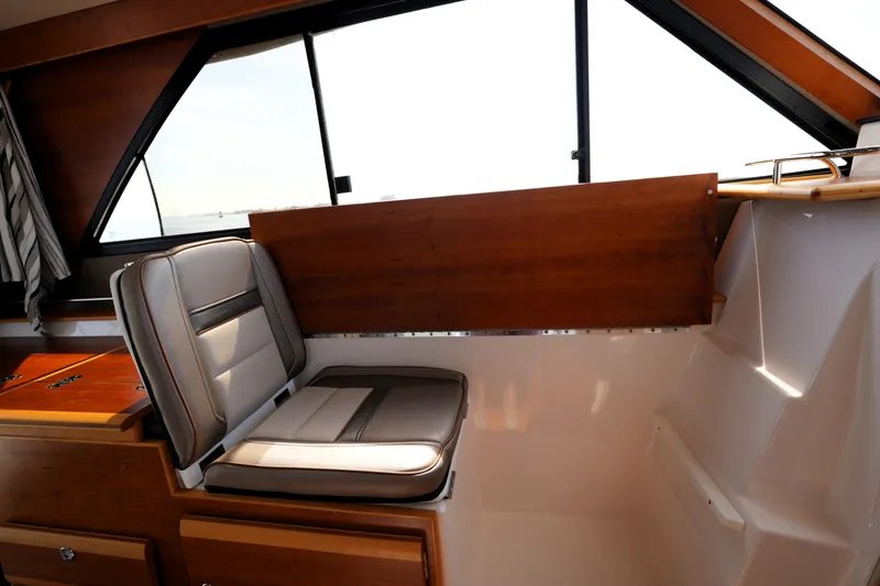 Slide: The Image of 2021 Cutwater C-32 CB interior with cushioned seating and wooden accents. - 31