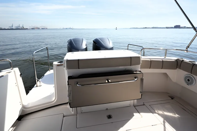 Slide: The Image of 2021 Cutwater C-32 CB boat deck with dual engines, overlooking calm waters. - 14