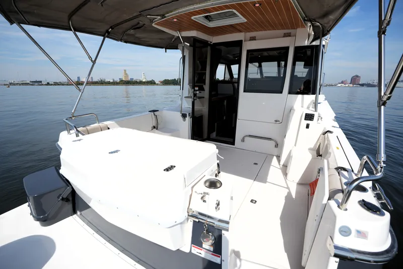 Slide: The Image of 2021 Cutwater C-32 CB boat with spacious deck, docked on calm water. - 13