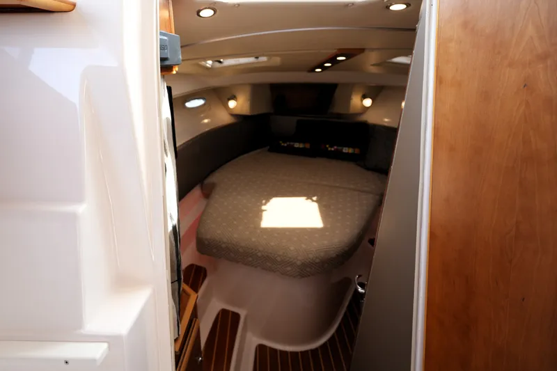 Slide: The Image of 2021 Cutwater C-32 CB cabin interior with cozy bed and modern lighting. - 42