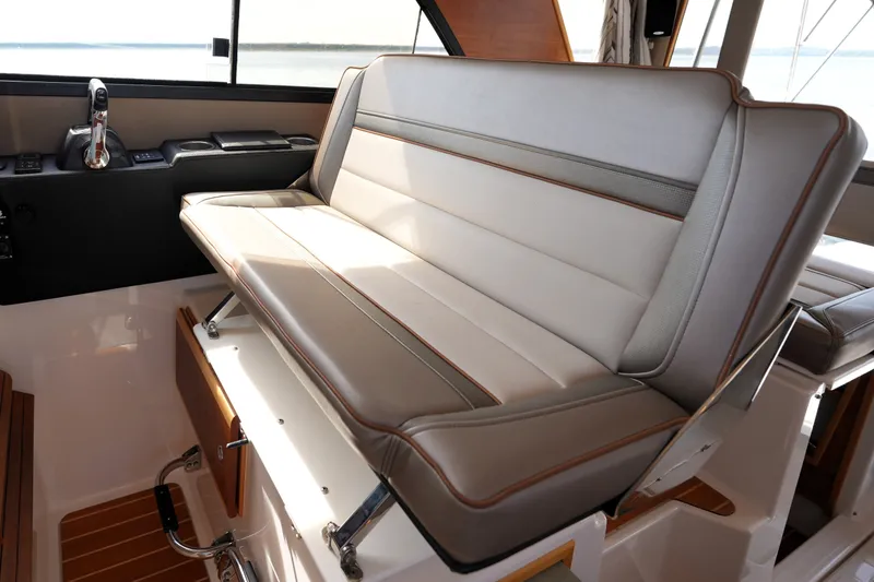 Slide: The Image of Interior seating of 2021 Cutwater C-32 CB boat, featuring luxurious beige upholstery. - 36