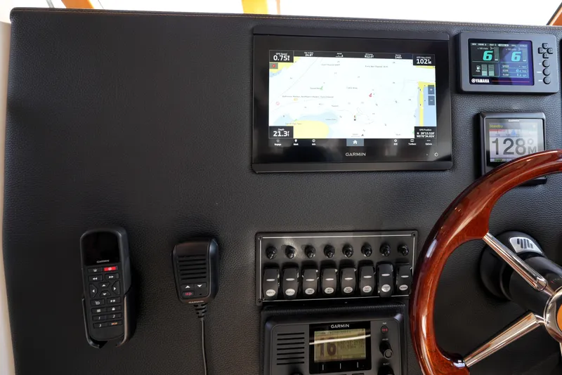 Slide: The Image of 2021 Cutwater C-32 CB helm with Garmin navigation, Yamaha display, and wood steering wheel. - 38