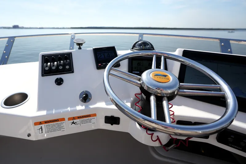 Slide: The Image of Helm of 2021 Cutwater C-32 CB boat with steering wheel and controls. - 24