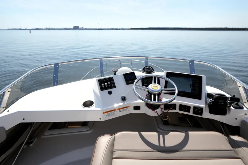 Slide: The Image of 2021 Cutwater C-32 CB helm with modern controls and panoramic water view. - 23