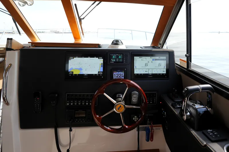 Slide: The Image of Helm of 2021 Cutwater C-32 CB boat with navigation screens and controls. - 37