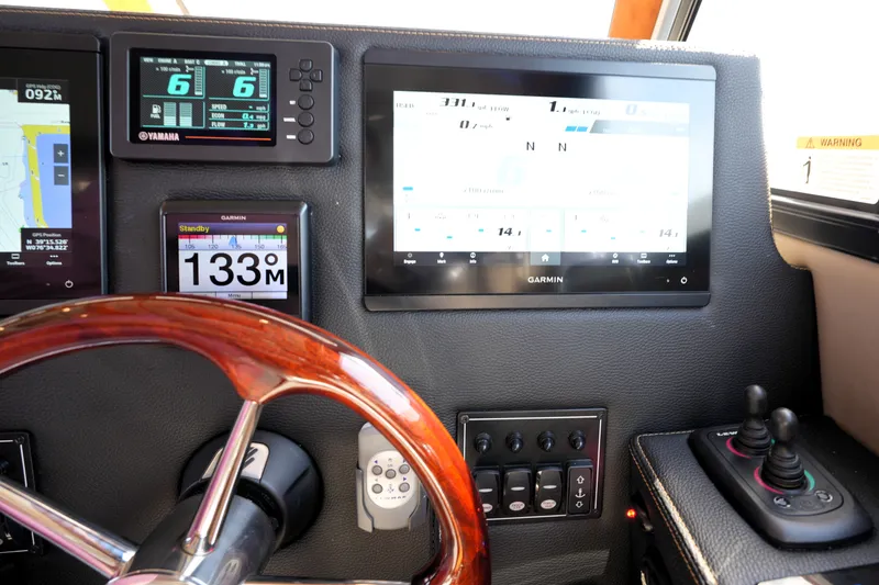 Slide: The Image of Dashboard of 2021 Cutwater C-32 CB with Garmin navigation and control systems. - 39