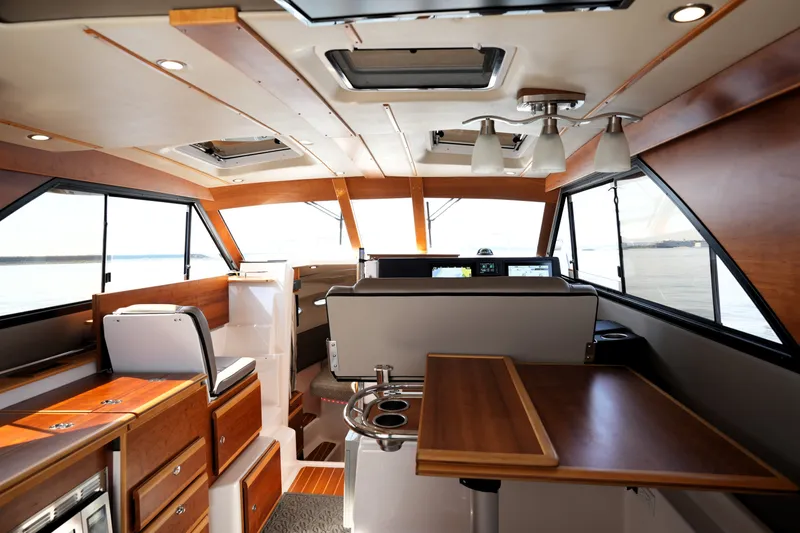 Slide: The Image of Interior of 2021 Cutwater C-32 CB boat, featuring modern wood finishes and spacious layout. - 28