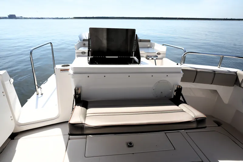 Slide: The Image of 2021 Cutwater C-32 CB boat deck with seating and grill, overlooking calm waters. - 15