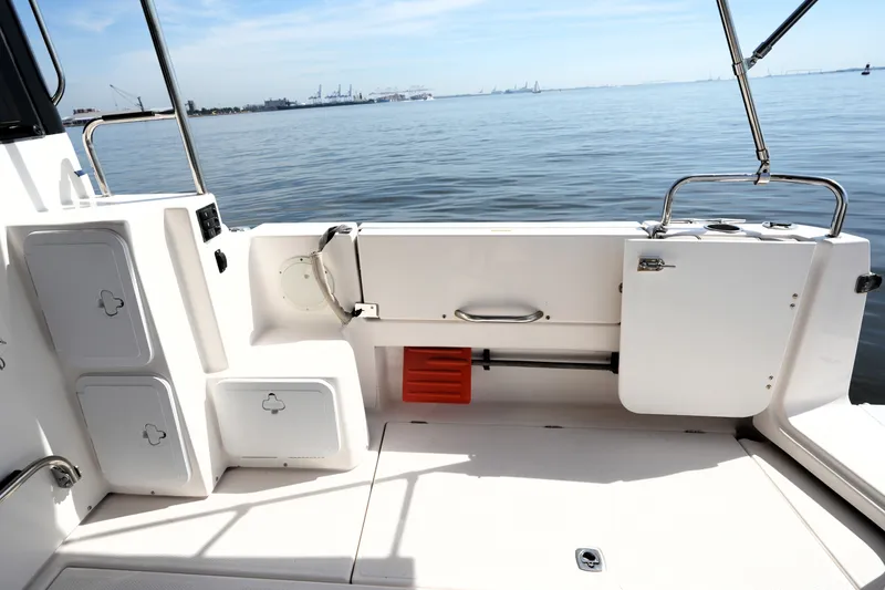 Slide: The Image of 2021 Cutwater C-32 CB boat deck with storage compartments, overlooking calm waters. - 17