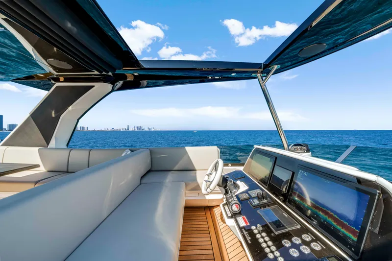 Slide: The Image of The Sunseeker Manhattan 68 cockpit features modern instruments and a luxurious seating area with ocean views. - 13