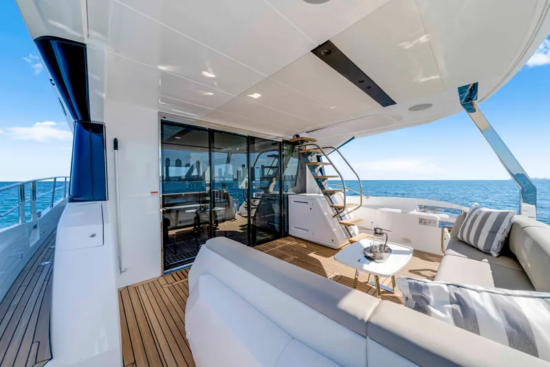 Slide: The Image of The 2027 Sunseeker Manhattan 68 features an elegant aft deck with luxurious seating and modern design. - 14