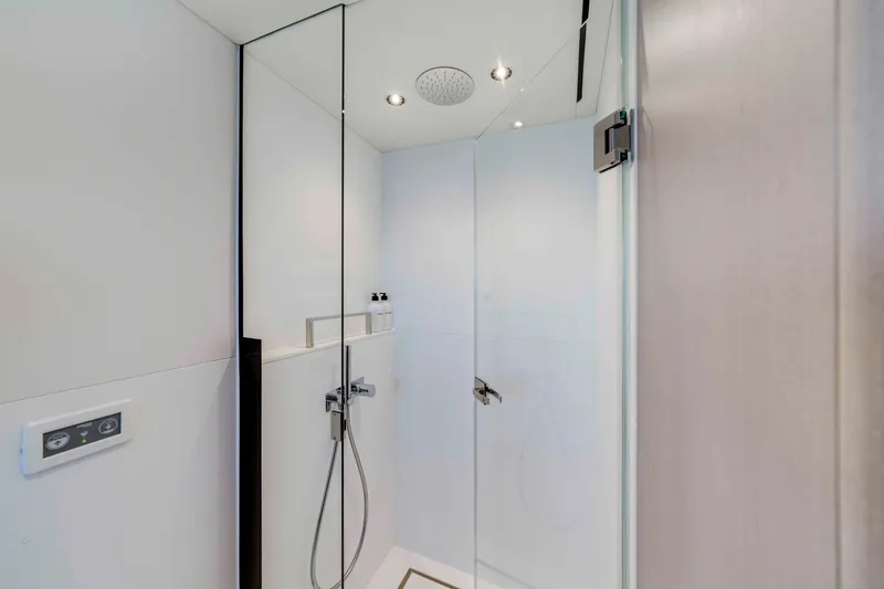 Slide: The Image of Modern bathroom with glass shower and sleek fixtures in a Sunseeker Manhattan 68 yacht model. - 41