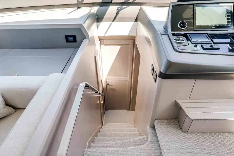 Slide: The Image of Interior view of a 2027 Sunseeker Manhattan 68 with stairs and helm console. - 26