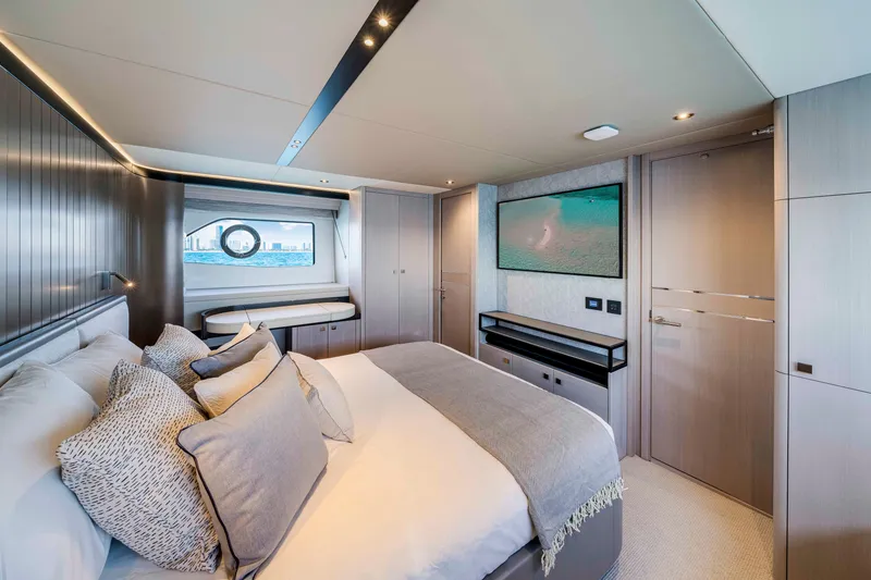 Slide: The Image of Luxurious cabin with a double bed, large windows, and modern decor on a Sunseeker Manhattan 68 yacht. - 38
