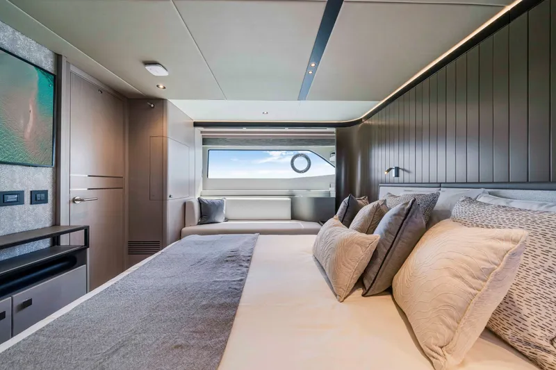 Slide: The Image of Luxurious cabin with a large bed, elegant pillows, and a panoramic window overlooking the sea. - 37