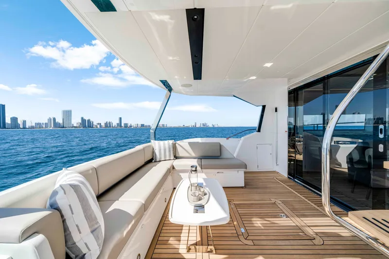 Slide: The Image of The 2027 Sunseeker Manhattan 68 features a sleek deck with comfortable seating and stunning skyline views. - 15