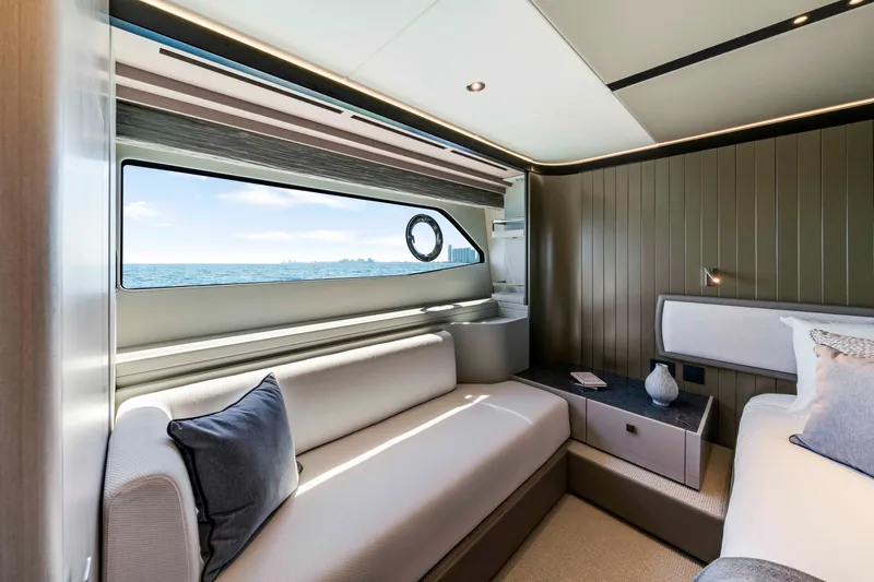 Slide: The Image of The luxurious cabin of the Sunseeker Manhattan 68 features a large window with sea view, a sofa, and a bed. - 39