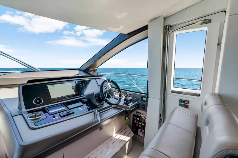 Slide: The Image of The cockpit of the Sunseeker Manhattan 68 features modern navigation equipment and comfortable seating with ocean views. - 24