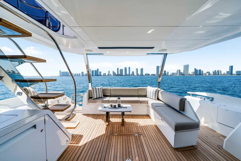 Slide: The Image of The image shows the deck of a 2027 Sunseeker Manhattan 68 with a skyline view. - 16
