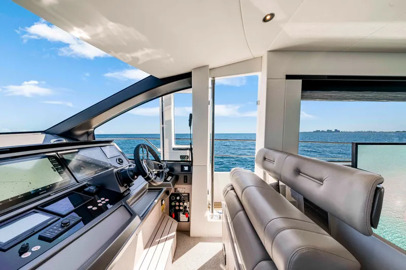Slide: The Image of The Sunseeker Manhattan 68 cockpit features modern instruments and a wide view of the sea. - 25