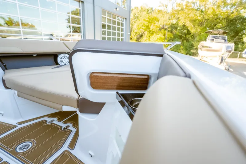 Slide: The Image of 2027 Monterey Elite 30 OB boat interior with beige seating and wood accents. - 36