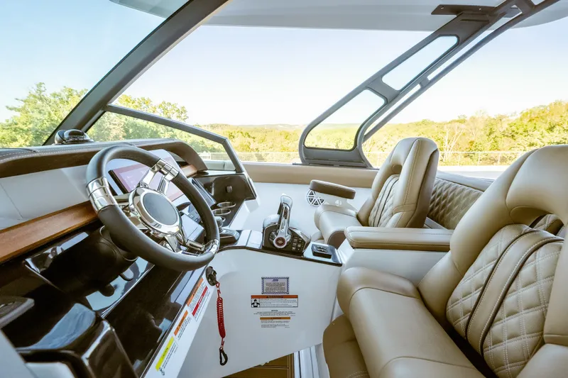 Slide: The Image of Luxurious interior of 2027 Monterey Elite 30 OB boat with plush seating and modern controls. - 31