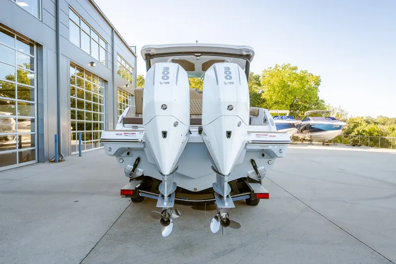 Slide: The Image of 2027 Monterey Elite 30 OB boat with dual 300 V8 engines, parked outdoors. - 14