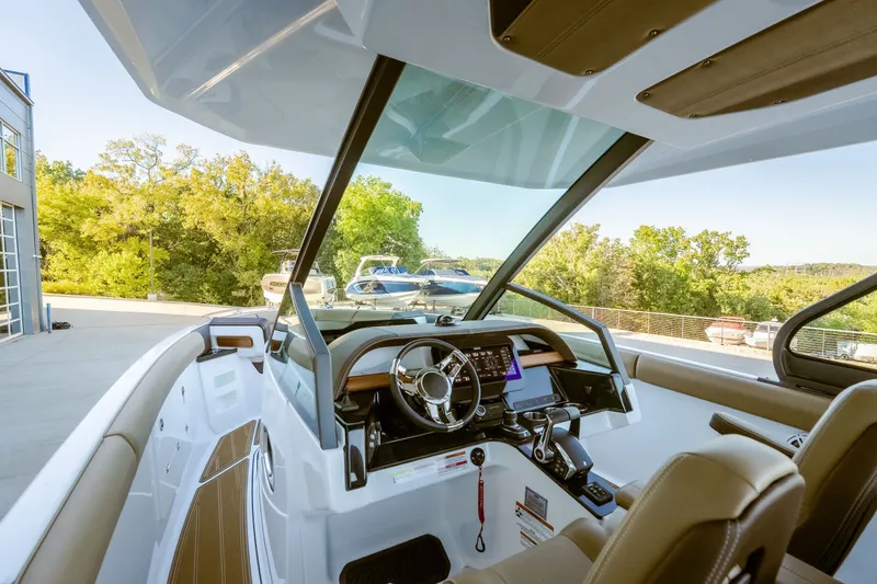 Slide: The Image of 2027 Monterey Elite 30 OB boat interior with modern dashboard and steering wheel. - 30
