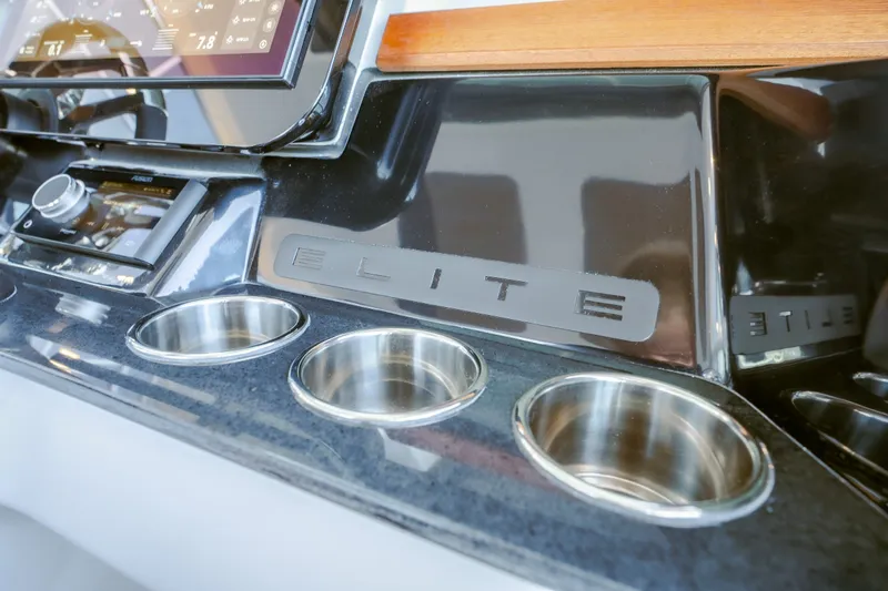 Slide: The Image of Dashboard of 2027 Monterey Elite 30 OB boat with cup holders and controls. - 22