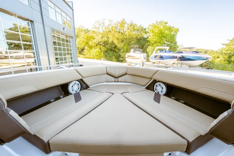 Slide: The Image of Luxurious seating area on the 2027 Monterey Elite 30 OB boat, docked near modern building. - 37