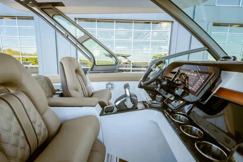 Slide: The Image of Luxurious interior of 2027 Monterey Elite 30 OB boat with modern dashboard and leather seating. - 32