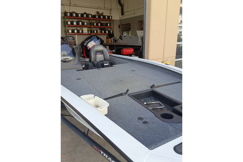 Slide: The Image of 2023 TRACKER PRO190 boat in a garage, showcasing spacious deck and seating. - 15
