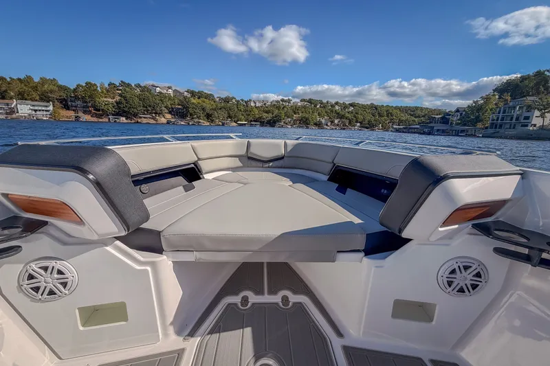 Slide: The Image of Luxurious seating on the 2027 Monterey Elite 27 OB boat, with scenic lake view. - 57