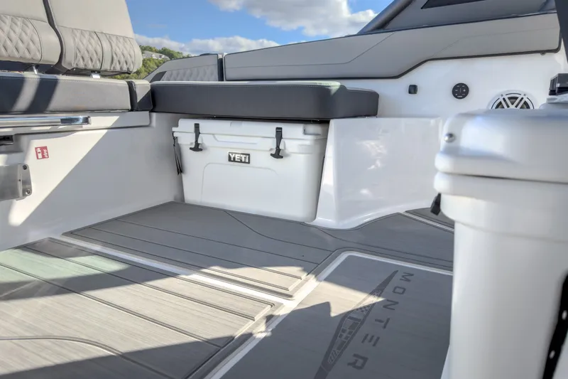 Slide: The Image of Interior of 2027 Monterey Elite 27 OB boat with seating and Yeti cooler. - 16