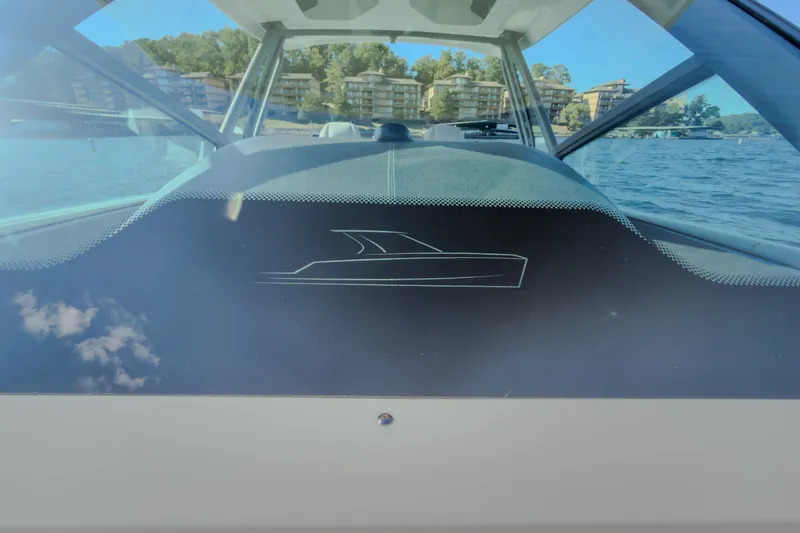 Slide: The Image of 2027 Monterey Elite 27 OB boat on a lake with scenic background. - 66