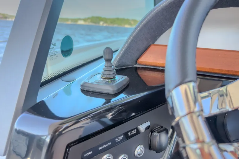 Slide: The Image of Close-up of 2027 Monterey Elite 27 OB boat dashboard with joystick control. - 75