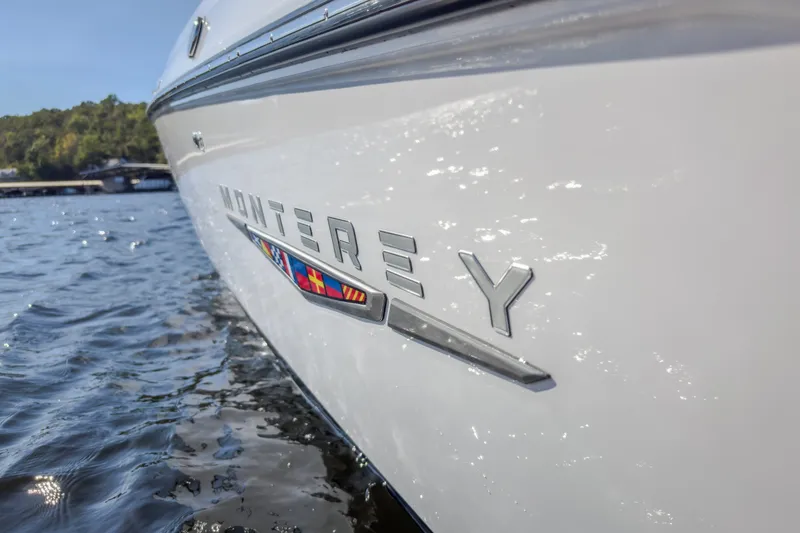 Slide: The Image of Close-up of 2027 Monterey Elite 27 OB boat on water, showcasing sleek design. - 39