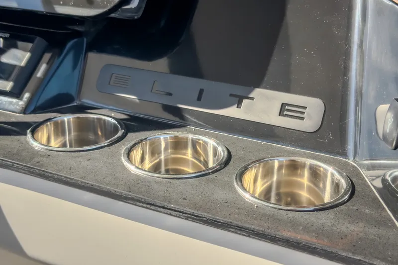 Slide: The Image of Dashboard of 2027 Monterey Elite 27 OB boat with cup holders and logo. - 72