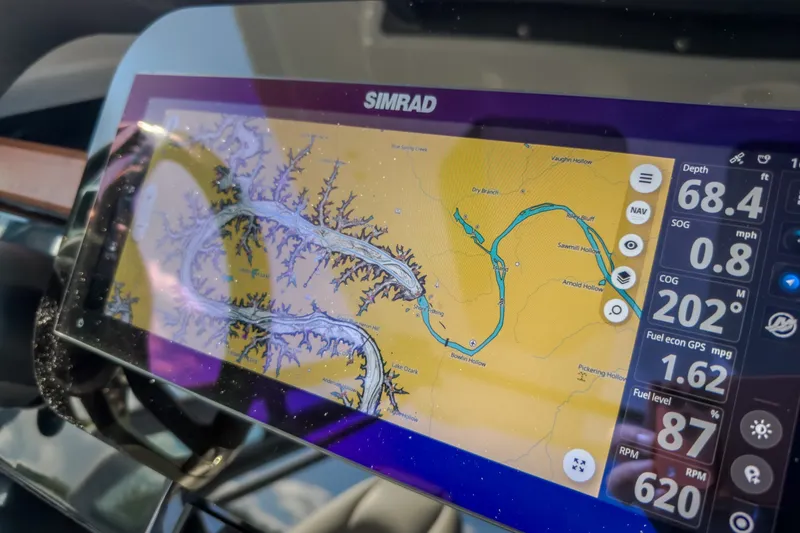 Slide: The Image of Simrad navigation display on 2027 Monterey Elite 27 OB boat, showing detailed waterway map. - 29
