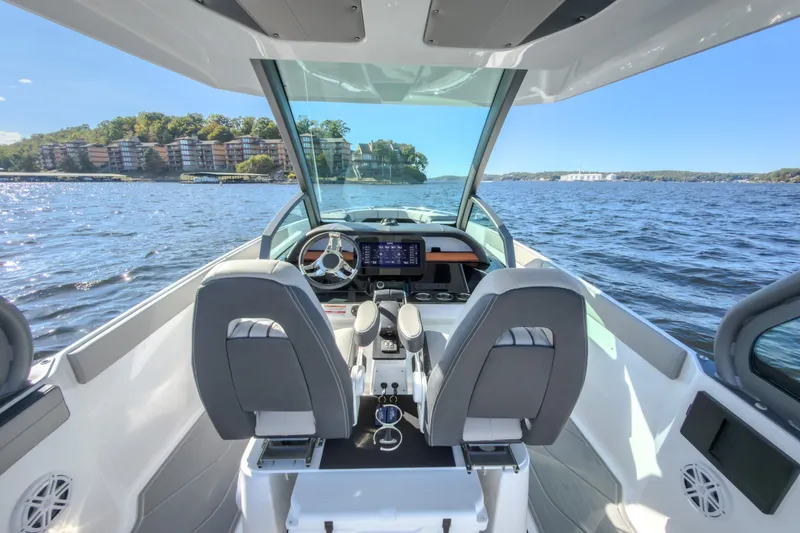 Slide: The Image of Interior view of 2027 Monterey Elite 27 OB boat on a scenic lake. - 44