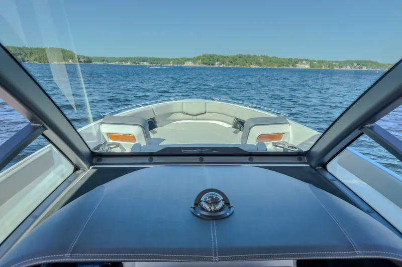 Slide: The Image of Interior view of 2027 Monterey Elite 27 OB boat on a serene lake. - 71
